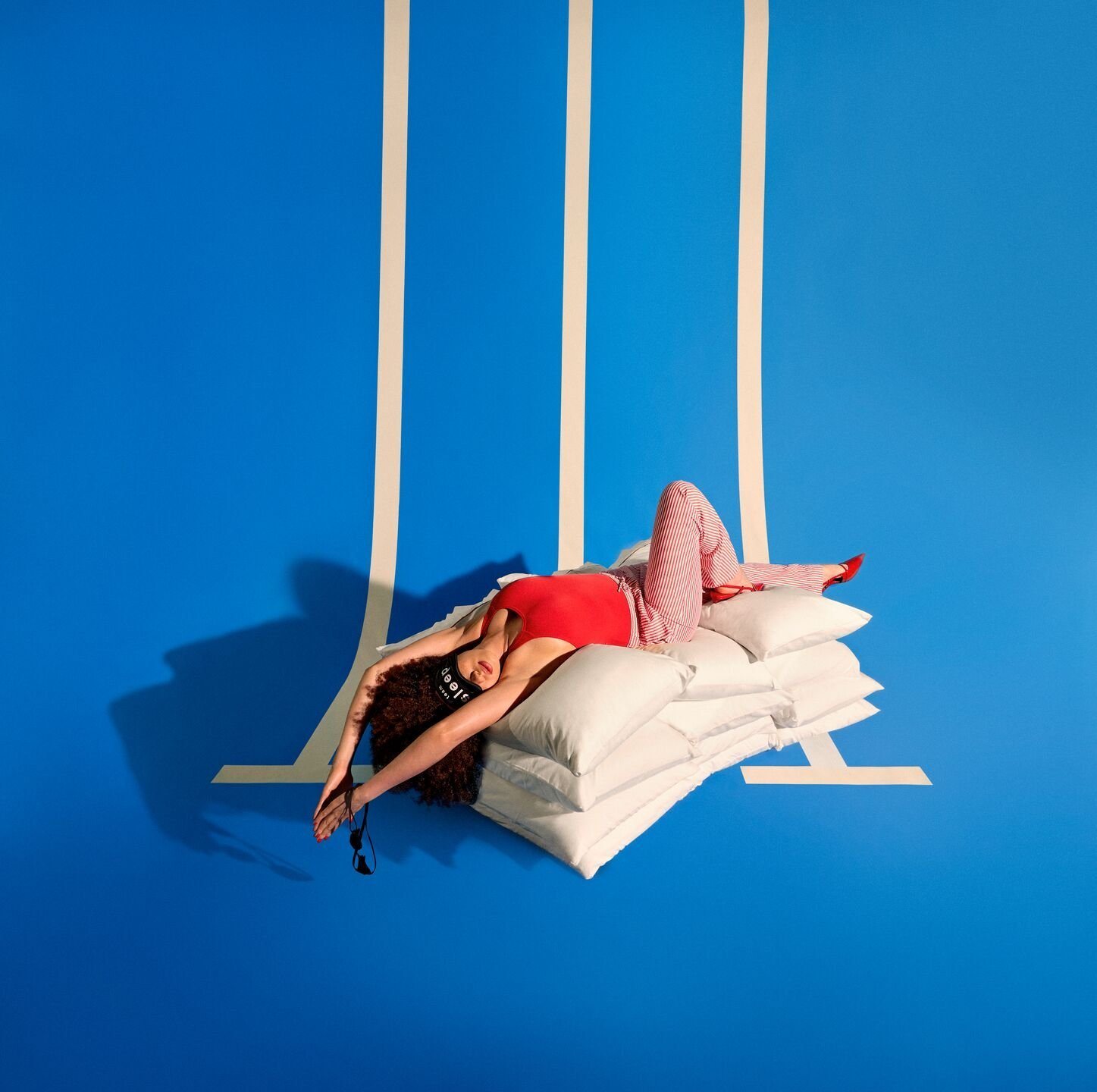 Summer Sale 2024: a swimmer asleep on pillows on a diving board