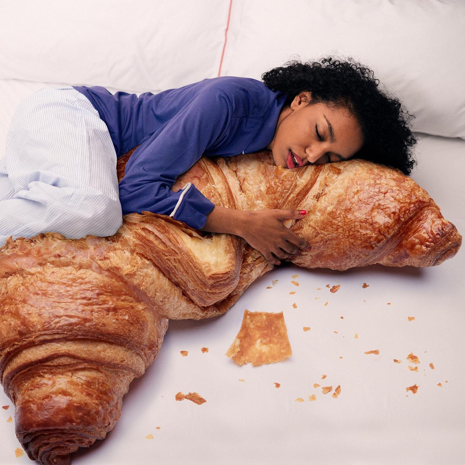Spring sale: a woman asleep on a giant croissant